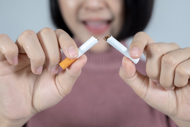 Young beautiful woman with broken cigarette