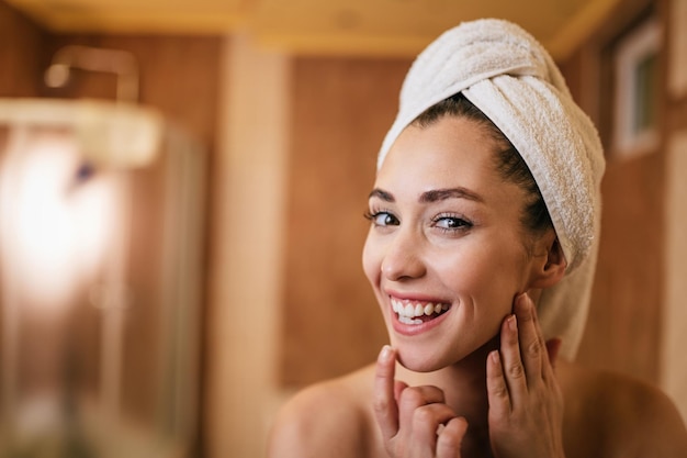 Young beautiful woman with clean and fresh face skin in the bathroom