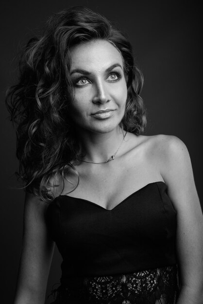 Young beautiful woman with curly hair posing in black and white