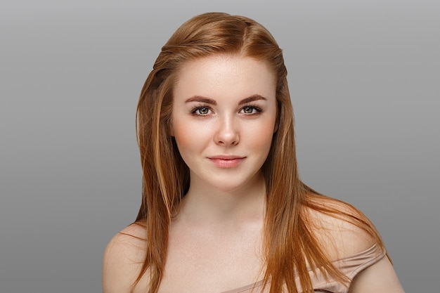 young beautiful woman with freckles portrait studio on light background hipster posing