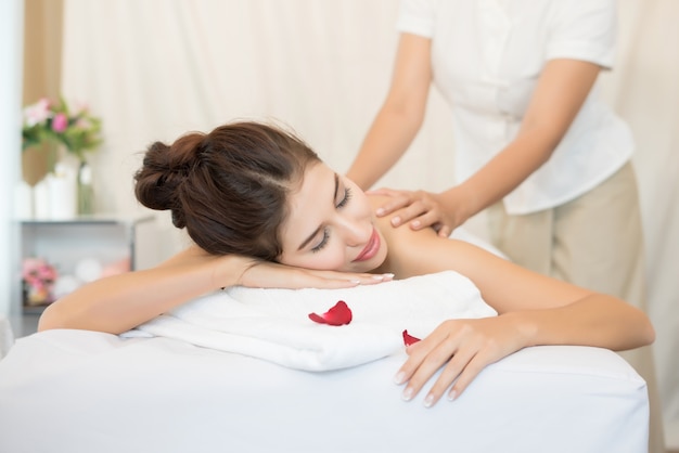 Young beautiful woman with healthy massage of body in the spa salon. Beauty concept.