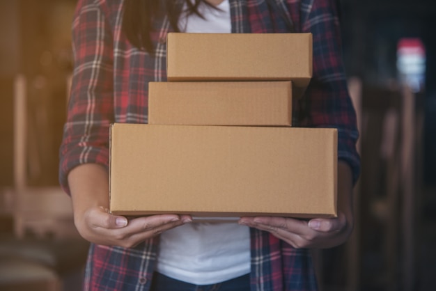 Young Beautiful woman with hold gift box in hands