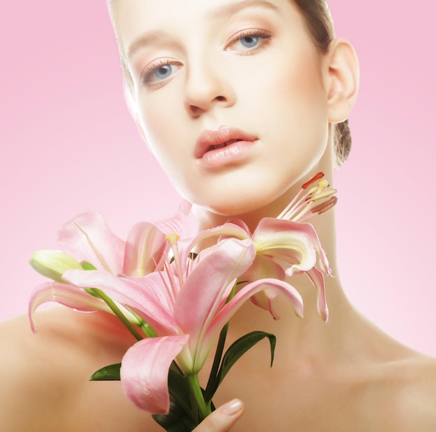 Young beautiful woman with a lily flowers