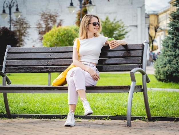 Young beautiful woman with linen eco bag on city background