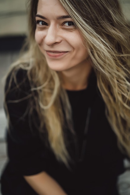 young beautiful woman with long hair outside posing portrait close-up.