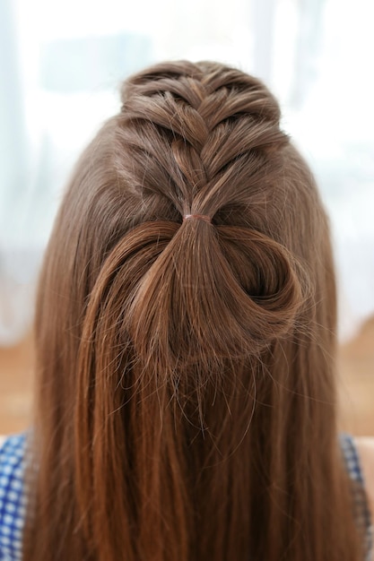 Young beautiful woman with nice braid hairstyle closeup