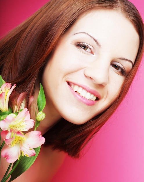 Young beautiful woman with pink flower