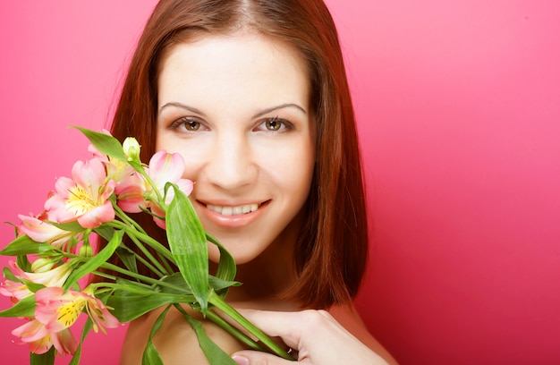 Young beautiful woman with pink flowers