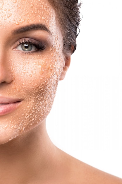 Young beautiful woman with sugar scrub on her face