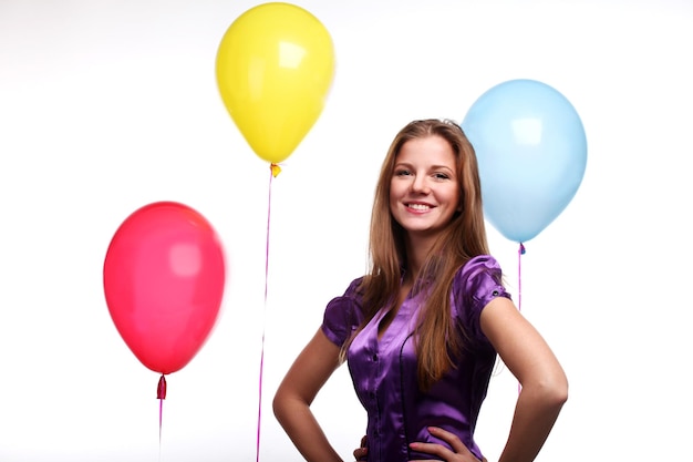 Young beautiful woman with three color balloons