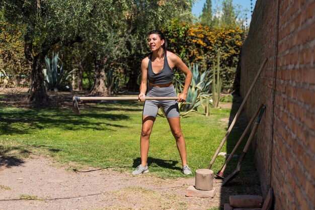 Young and beautiful woman working on the land skinny muscular hardworking working woman