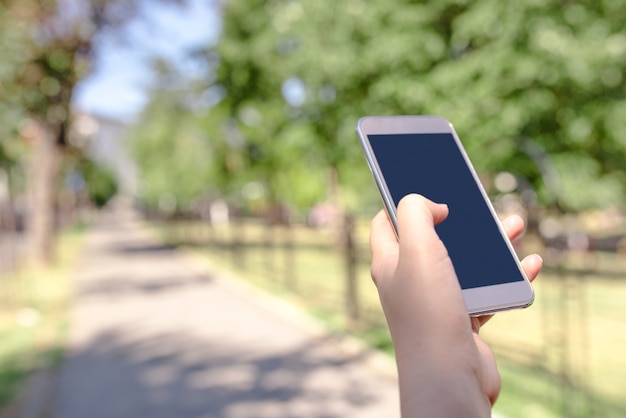 Young beautiful woman writes an SMS to your mobile phone