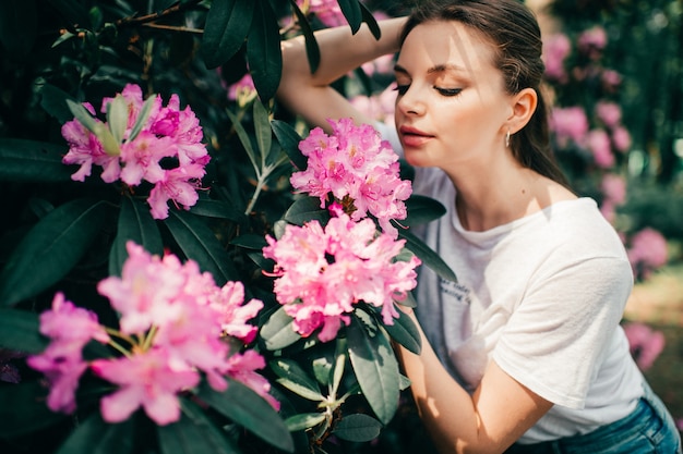 Young beautiful womanposing among the flowering tree