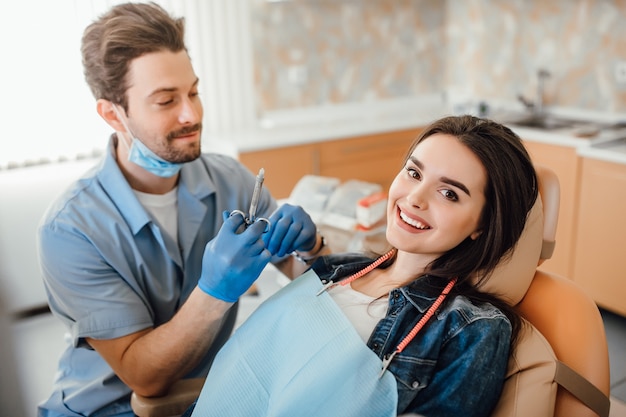 Young beautiful young adult woman getting dental anesthesia.