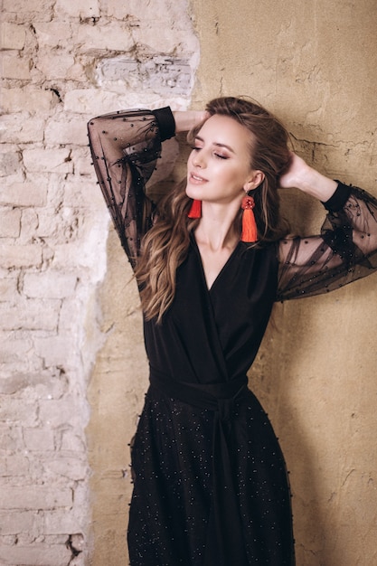 Young beauty woman portrait in black dress. 