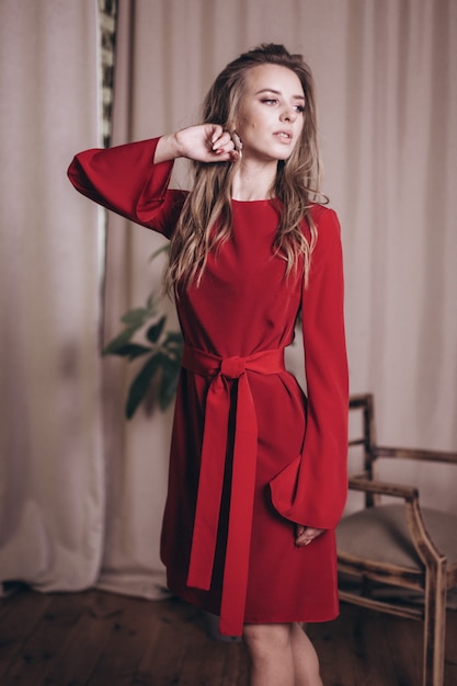 Young beauty woman portrait in red dress. 