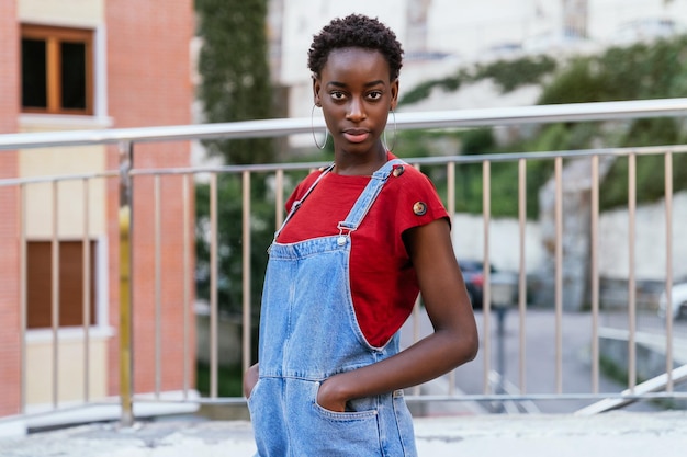 Young black African woman model posing on the street with an intense and very fashionable look