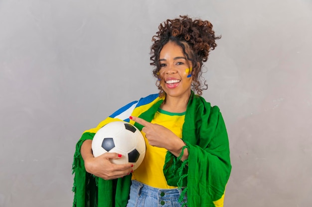 Photo young black brazilian soccer fan pointing left publicity photo