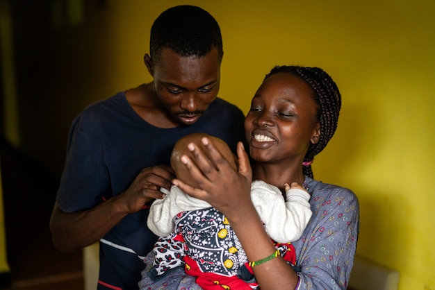 Young black family happy mom and dad holding baby