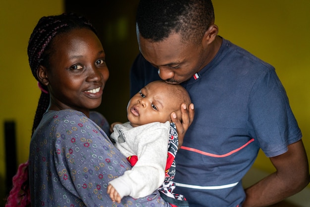 Young black family happy mom and dad holding baby