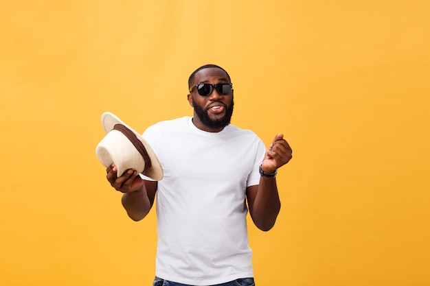 Young black man top dancing isolated on a yellow background.