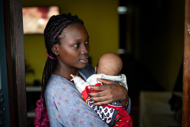 Young black mother holding baby