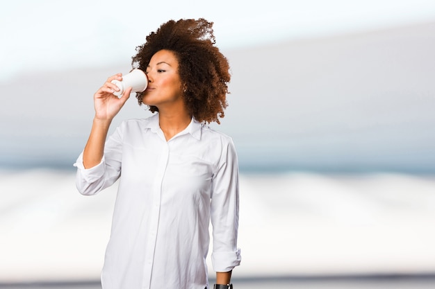 young black woman drinking a coffee