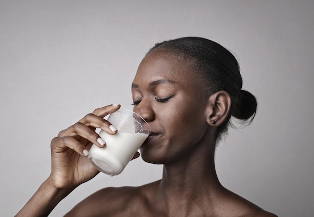 young black woman drinks milk