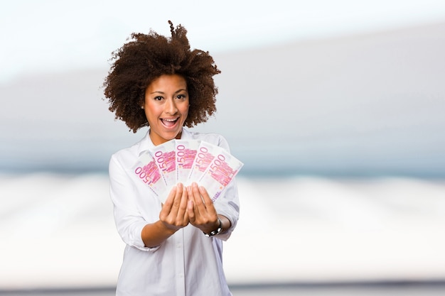 young black woman holding bills