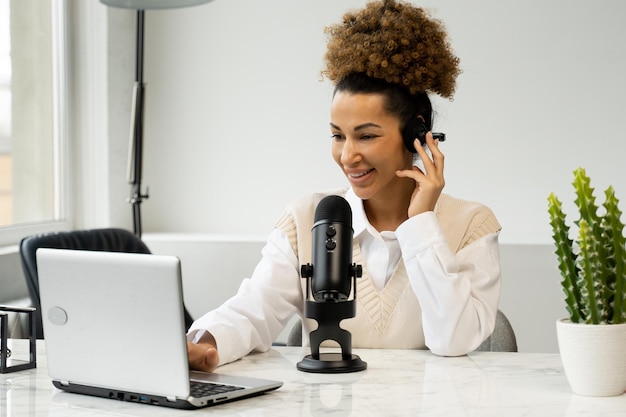 Young black woman is making an online podcast recording for her online show an attractive