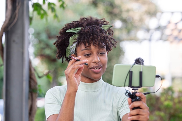 Young blogger artist recording makeup tutorial to share on website or social media