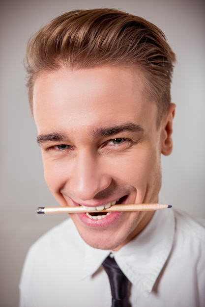 Young blond businessman in white classical shirt.