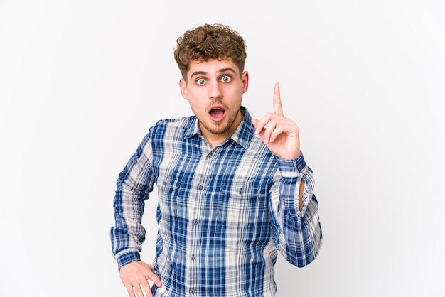 Young blond curly hair caucasian man isolated having an idea