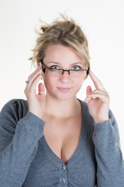 Young blond woman with glasses and grey top