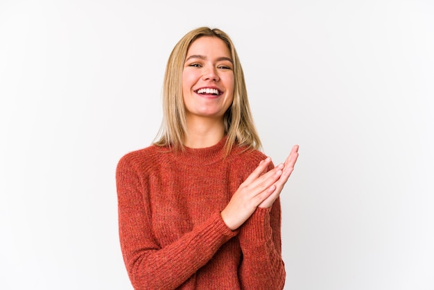 Young blonde caucasian woman isolated feeling energetic and comfortable, rubbing hands confident.