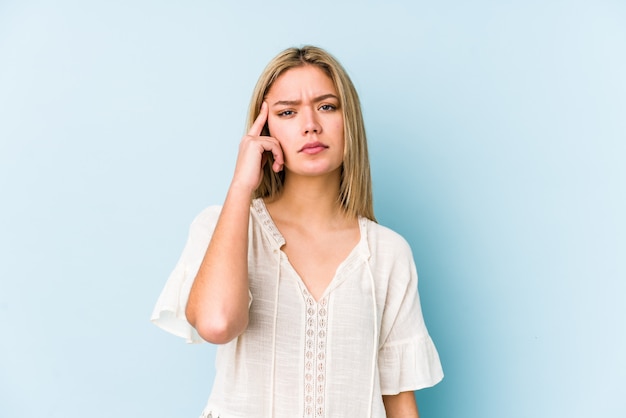 Young blonde caucasian woman isolated showing a disappointment gesture with forefinger.