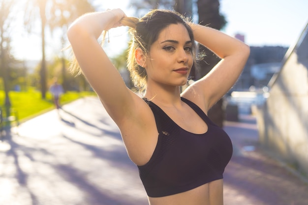 Young blonde Caucasian woman warming up before doing sports