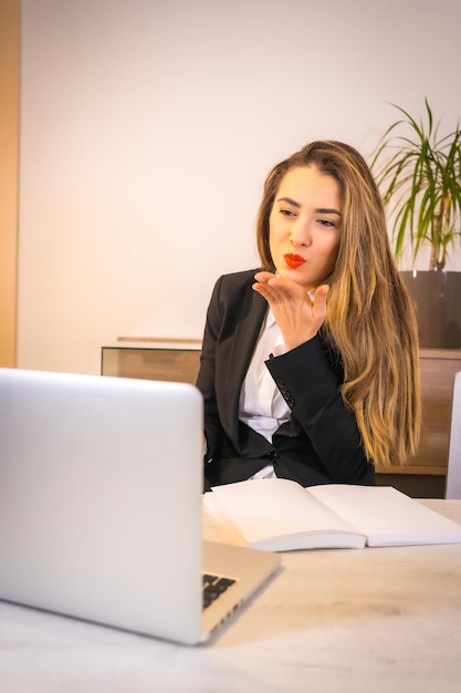 Young blonde Caucasian woman with a coffee working with the computer