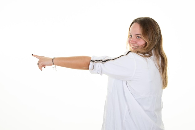 Young blonde curvy woman over white background pointing hand side finger on white background