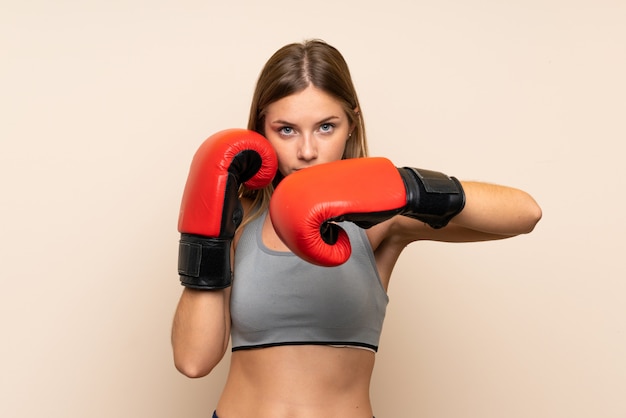 Young blonde girl with boxing gloves