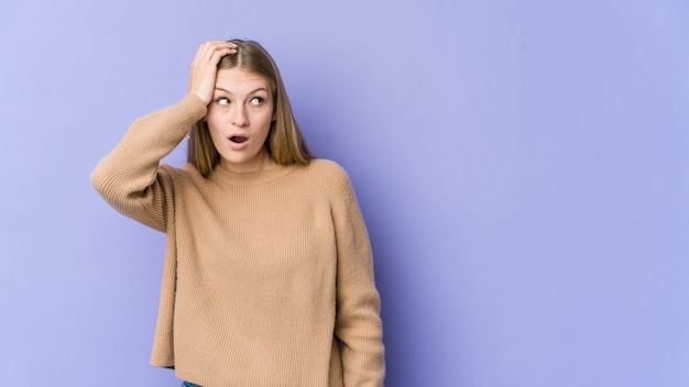 Young blonde woman being shocked, she has remembered important meeting