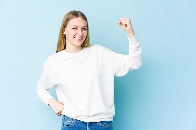 Young blonde woman cheering carefree and excited. Victory concept.