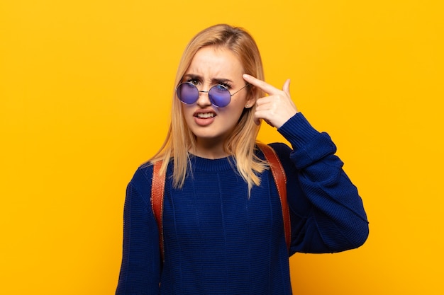 Young blonde woman feeling confused and puzzled