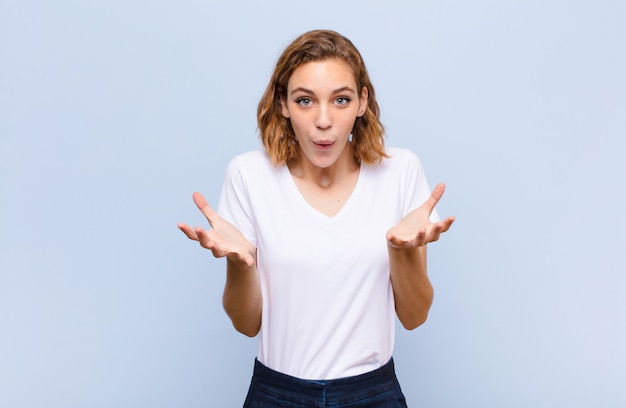 Young blonde woman feeling extremely shocked and surprised