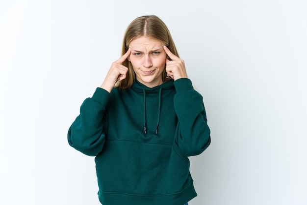 Young blonde woman focused on a task, keeping forefingers pointing head