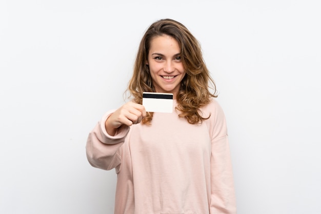 Young blonde woman holding a credit card