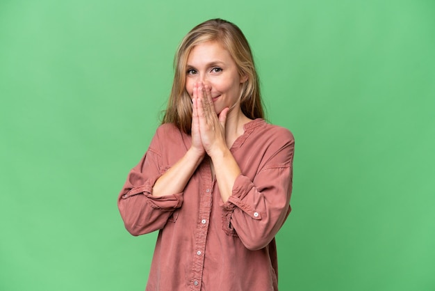 Young blonde woman over isolated background keeps palm together Person asks for something