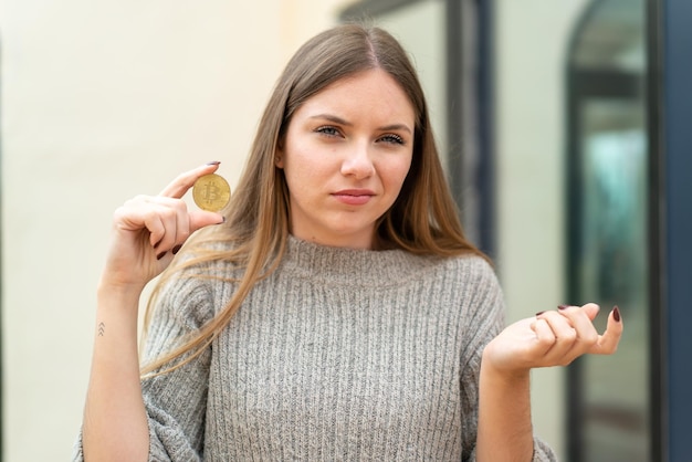 Young blonde woman over isolated background