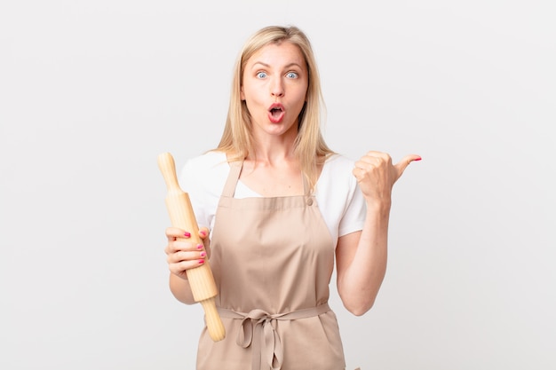 Young blonde woman looking astonished in disbelief. baker concept