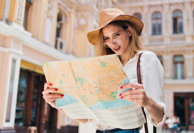 Young blonde woman looking the city map